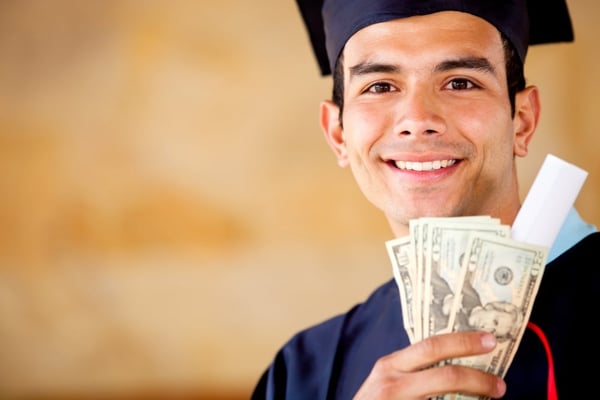 Male graduated holding money - Education costs concepts